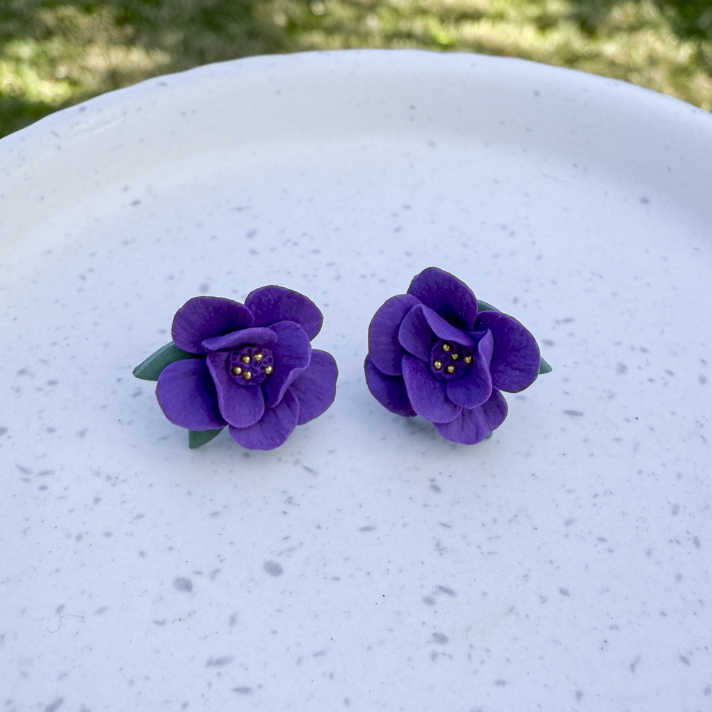 Violet flower studs with leaves