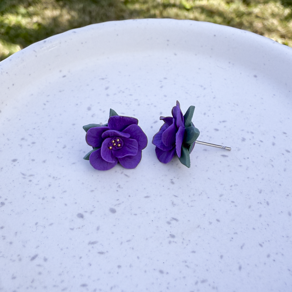 Violet flower studs with leaves