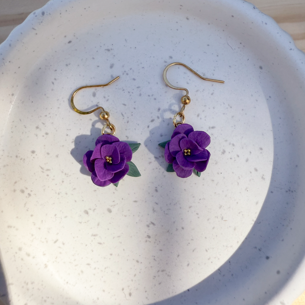Violet flower dangles with leaves